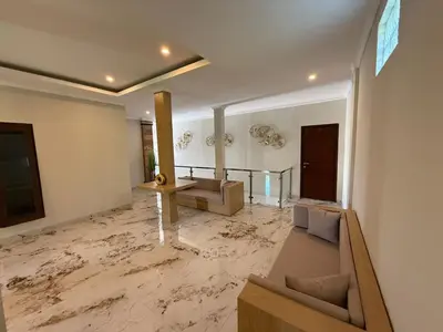 a living room with a floor covered in marble at Mara inn in Nusa Dua