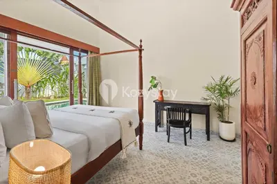 a bedroom with a bed and a desk at Andrew Villa by Kozystay - Umalas in Canggu