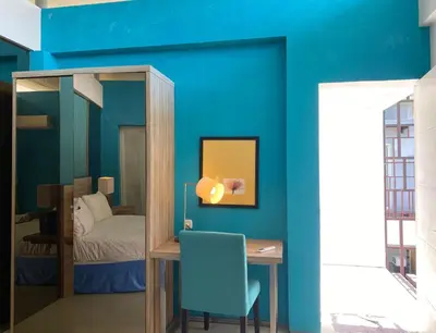 a blue room with a desk and a bed at 2 bedroom with pool tropical in Nusa Dua