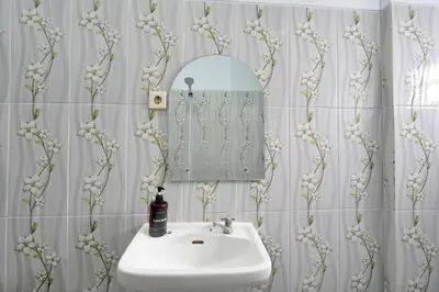 a bathroom with a sink and a mirror at Kamar Kodel2 Apt in Seminyak