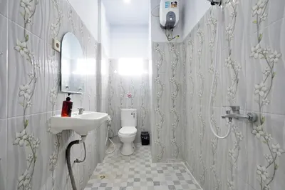 a bathroom with a sink and a toilet at Kamar Kodel2 Apt in Seminyak
