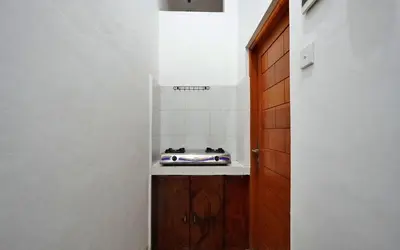 a small kitchen with a stove in a room at Kamar Kodel1 in Seminyak