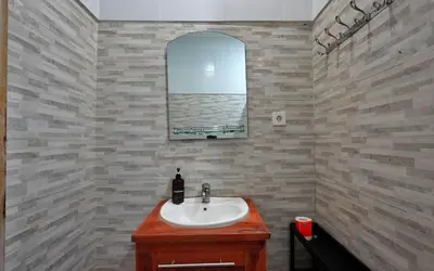 a bathroom with a sink and a mirror at Kamar Kodel1 in Seminyak