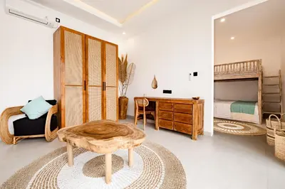 a room with a desk and a bed and a table at Brand new - spacious complex Villas Virland - center Seminyak in Seminyak