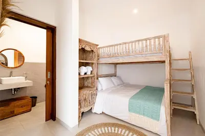 a bedroom with a bunk bed with a ladder at Brand new - spacious complex Villas Virland - center Seminyak in Seminyak
