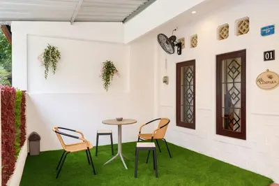 a room with a table and chairs on grass at Villa Cempaka - Pemogan in Denpasar