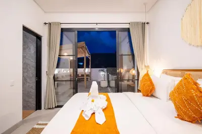 a bedroom with a bed with a flower on it at Villa Esha I in Seminyak
