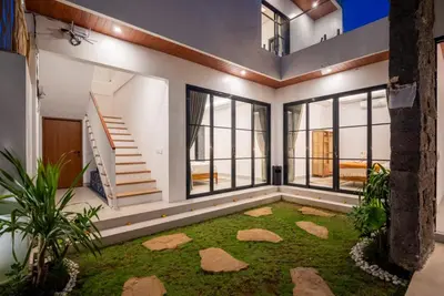 a large living room with a rug in the middle at Villa Esha I in Seminyak