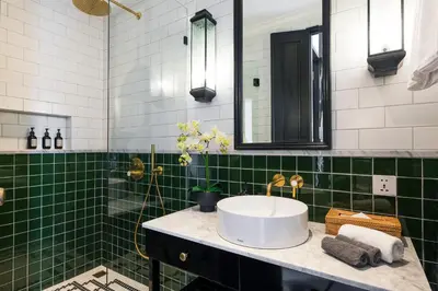 a bathroom with a sink and green tiles at Martini Beachside Villa 6 in Canggu