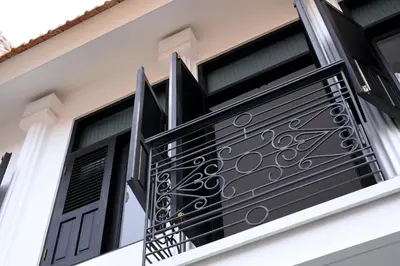 a window with a black iron railing on a house at Martini Beachside Villa 6 in Canggu