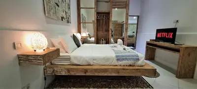 a bedroom with a bed on a wooden table at Tropical 2br private pool Villa in central Seminyak in Seminyak
