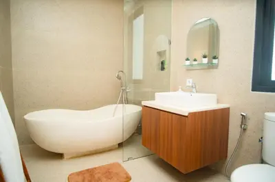 a bathroom with a white tub and a sink at Modern tropical House Villa in Seminyak