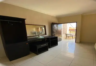 a room with a mirror and a dresser with a lamp at Hotel Near Beach Ayu inn Kuta in Kuta