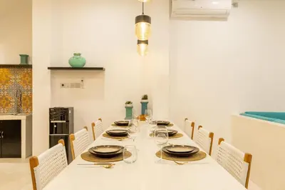 a dining room with a long table with chairs at Aaryan Villa 1 in Seminyak