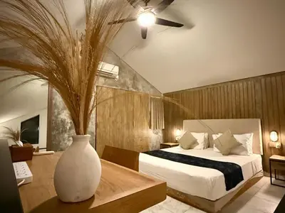 a bedroom with a bed and a vase on a table at Ambara Villa - Quiet Luxury in Umalas in Canggu