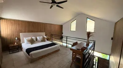 a bedroom with a bed and a ceiling fan at Ambara Villa - Quiet Luxury in Umalas in Canggu