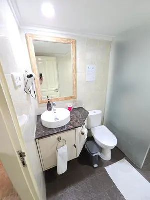 a bathroom with a sink and a toilet and a mirror at Classic Balinese Stay Jayakarta - 5 min walk to Kuta beach AC WiFi ! in Kuta