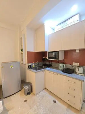 a kitchen with a sink and a refrigerator at Classic Balinese Stay Jayakarta - 5 min walk to Kuta beach AC WiFi ! in Kuta