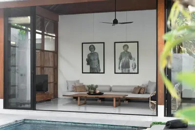 a living room with a couch and a tv at Villa Under the Sun - Seminyak in Seminyak