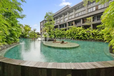a swimming pool in the middle of a building at Rivana by Kozystay - Nusa Dua in Nusa Dua