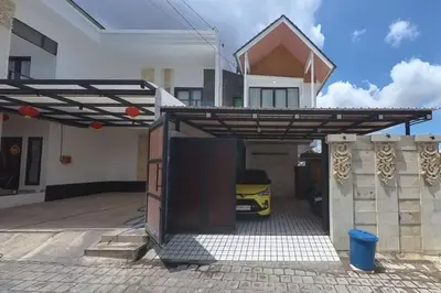 a house with a garage with a car under awning at Villa 9 in Seminyak