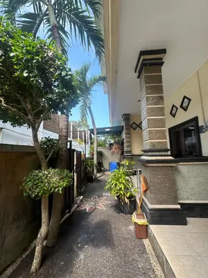 a courtyard with trees and plants in a building at OSA Guest House in Seminyak