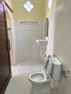 a bathroom with a toilet and a sink at OSA Guest House in Seminyak
