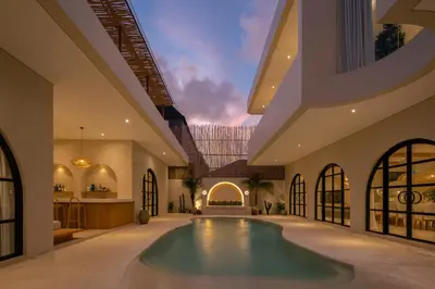 an indoor pool in a building with a ceiling at Brand New Exquisite Luxury 5 BR Villa Umalas in Kerobokan