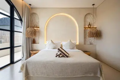 a bedroom with a bed and a large window at Brand New Exquisite Luxury 5 BR Villa Umalas in Kerobokan