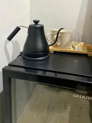 a black tea kettle sitting on top of a microwave at Zen Home in Jimbaran