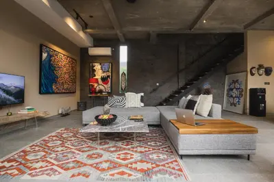 a living room with a couch and a table with a laptop at DUNE ARRAKIS villas in Seminyak