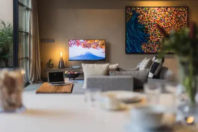 a living room with a couch and a tv at DUNE ARRAKIS villas in Seminyak