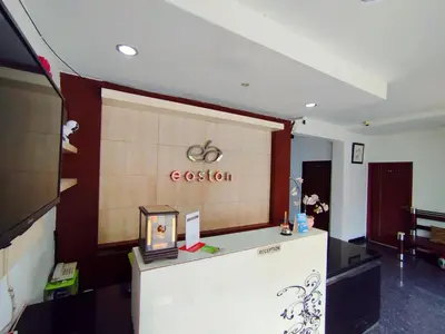 an office with a reception desk and a sign on a wall at Easton Homestay in Ngurah Rai International Airport