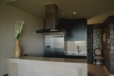 a kitchen with a stainless steel refrigerator and a sink at Luxury Apartment at AYANA Residences in Jimbaran