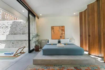 a bedroom with a blue bed in a room at Villa Kanan Seminyak - Stylish 2BR Villa Private Pool in Seminyak