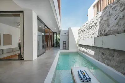 a swimming pool in the middle of a house at Villa Kanan Seminyak - Stylish 2BR Villa Private Pool in Seminyak
