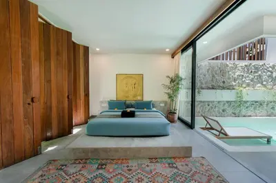 a bedroom with a bed and a swimming pool at Villa Kiri - Modern 2BR Hideaway Rooftop & Private Pool in Seminyak