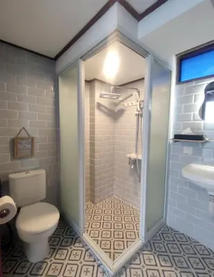 a bathroom with a shower and a toilet and a sink at Bashania in Kerobokan