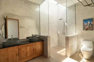 a bathroom with two sinks and a shower at Ben's Villa 1 by Alfred in Bali in Kerobokan