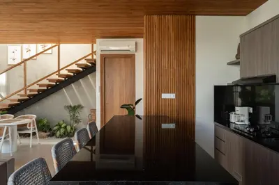 a kitchen with a table and chairs and a staircase at Ben's Villa 1 by Alfred in Bali in Kerobokan