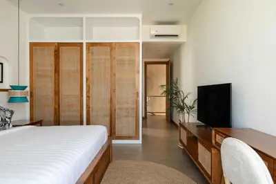 a bedroom with a bed and a flat screen tv at Ben's Villa 2 by Alfred in Bali in Kerobokan