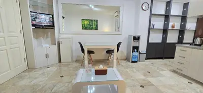a kitchen with a table and chairs in a room at The Palmana Tropical Courtyard Jayakarta Residence 12 in Seminyak