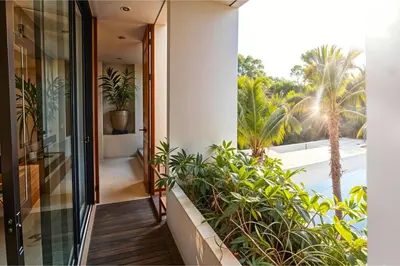 an indoor balcony with plants and a view of the pool at Casa Ipanema, Luxury 2 Bedrooms Villa with Cinema in Private Quiet Area in Canggu