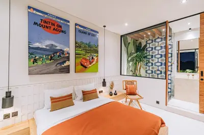a bedroom with a bed and two posters on the wall at Casa Ipanema, Luxury 2 Bedrooms Villa with Cinema in Private Quiet Area in Canggu