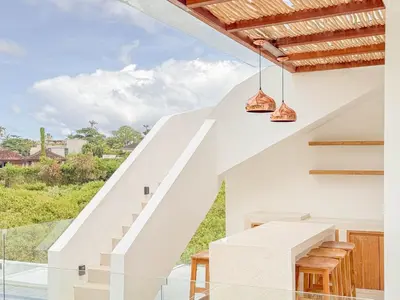 a staircase leading up to a house with a view at Anjou - Twin Villa in Berawa Canggu in Canggu