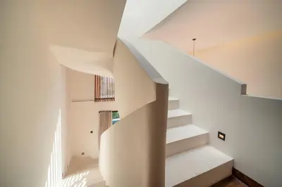 a staircase in a house with white walls at Stylish 4 bedroom Villa in Prime Location in Canggu