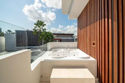a bathroom with a white sink on a balcony at Stylish 2 bedroom Villa in Prime Location in Canggu