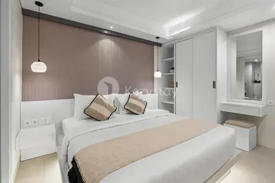 a bedroom with a white bed and a wall at Alva by Kozystay - Nusa Dua in Nusa Dua