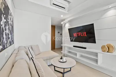 a living room with a couch and a tv at Alva by Kozystay - Nusa Dua in Nusa Dua