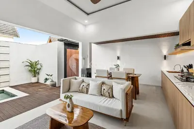 a living room with a couch and a table at Navaya Villa by Kozystay - Seminyak in Seminyak